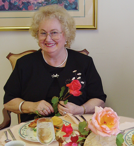 Resident holding rose in dining room